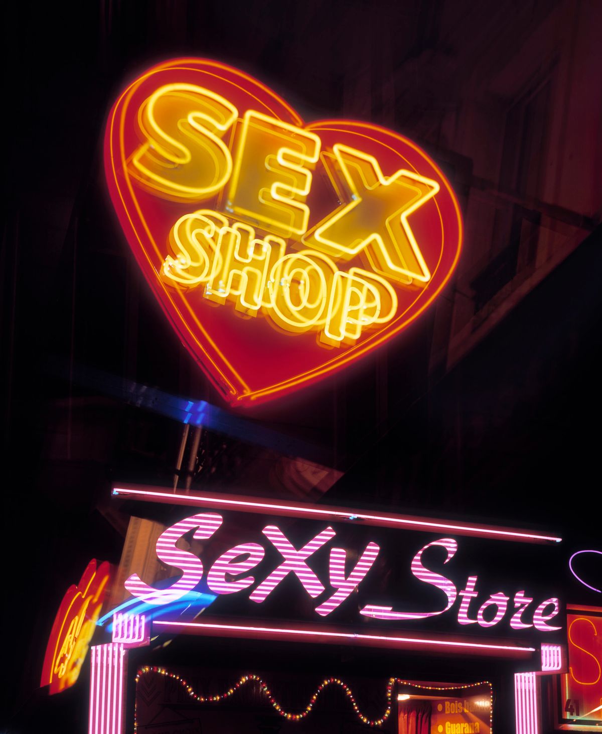 A neon lit sign of a sex shop in Pigalle, Paris