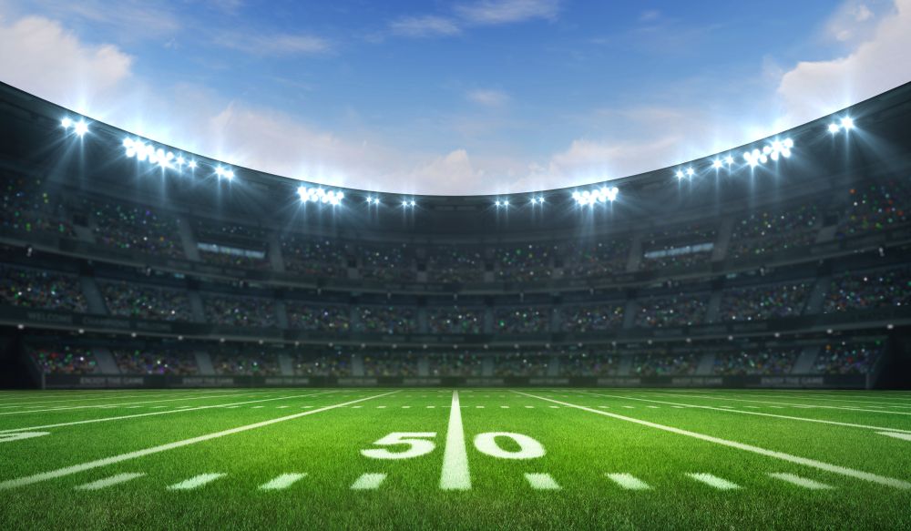 American,Football,League,Stadium,With,White,Lines,And,Fans,,Daytime