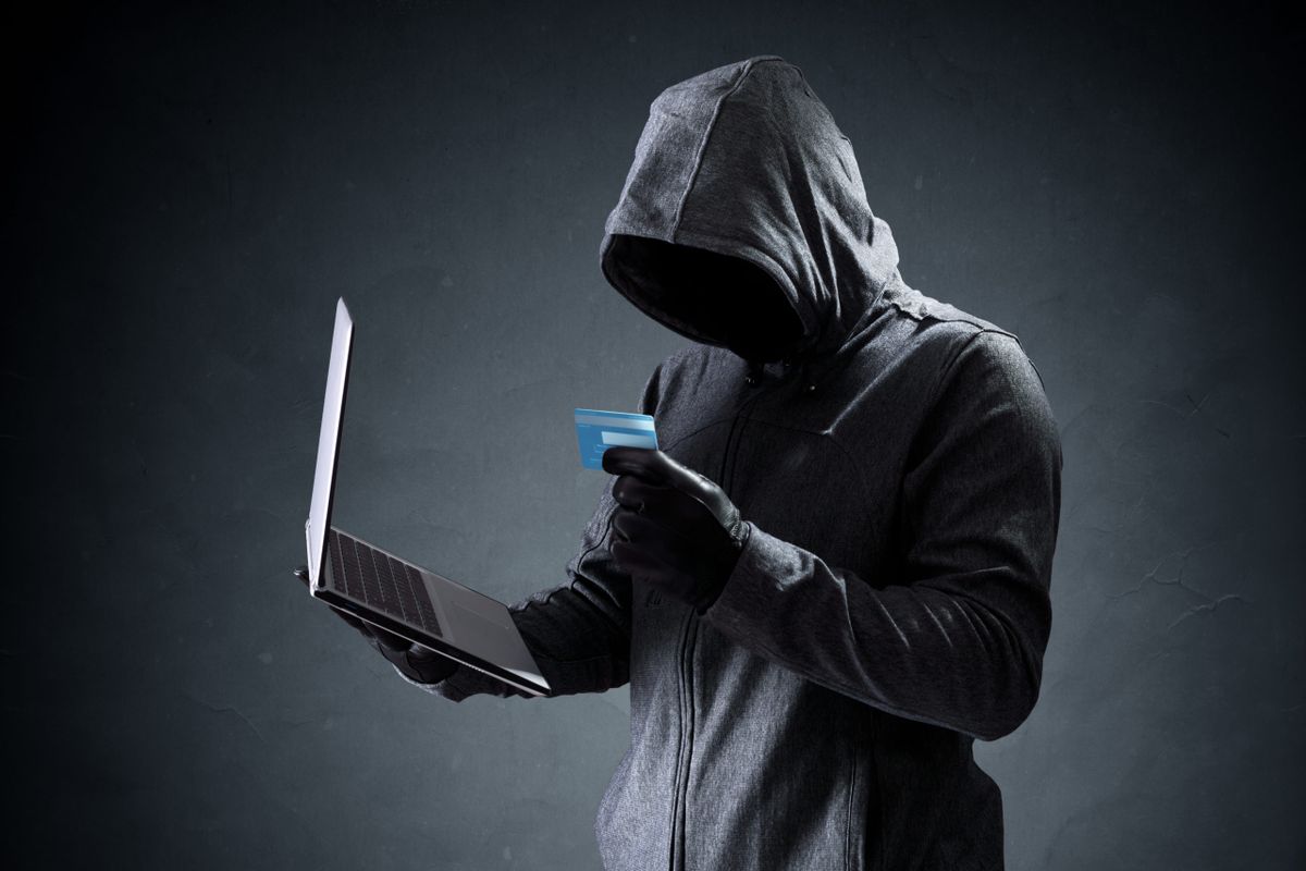 Computer,Hacker,With,Credit,Card,Stealing,Data,From,A,Laptop