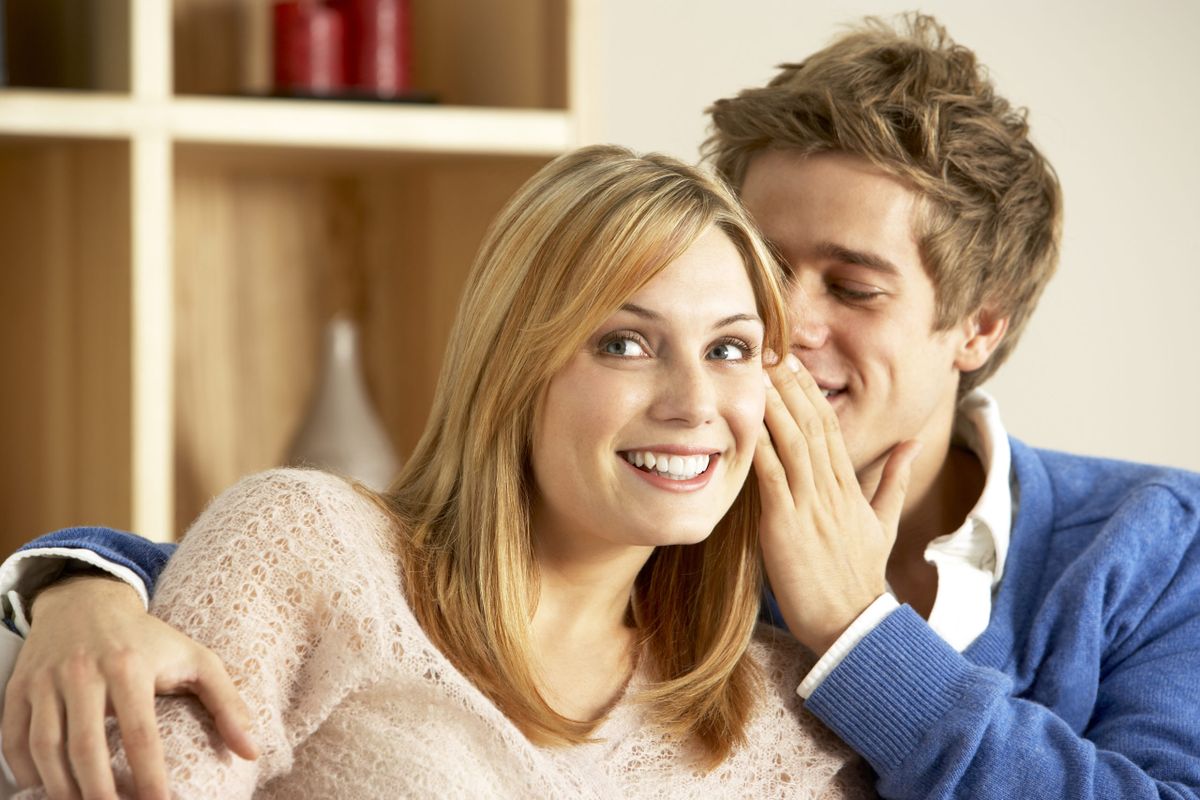 Young,Couple,Whispering,To,Each,Other