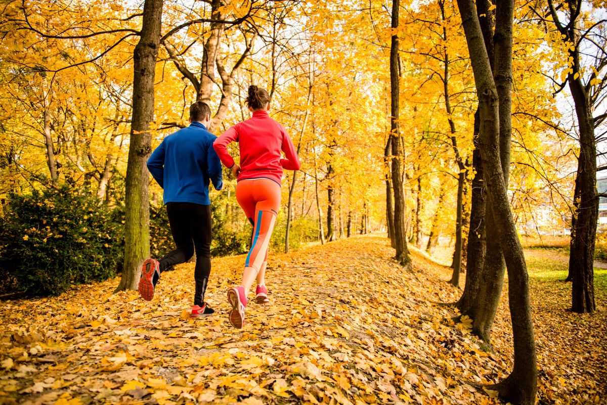 Running,Together,-,Young,Couple,Jogging,In,Autumn,Park,,Rear
