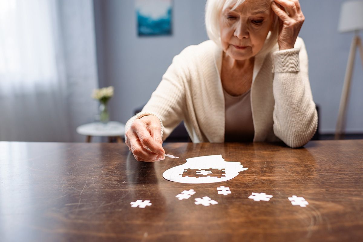 Senior,Woman,Combining,Jigsaw,Puzzle,For,Dementia,Rehabilitation