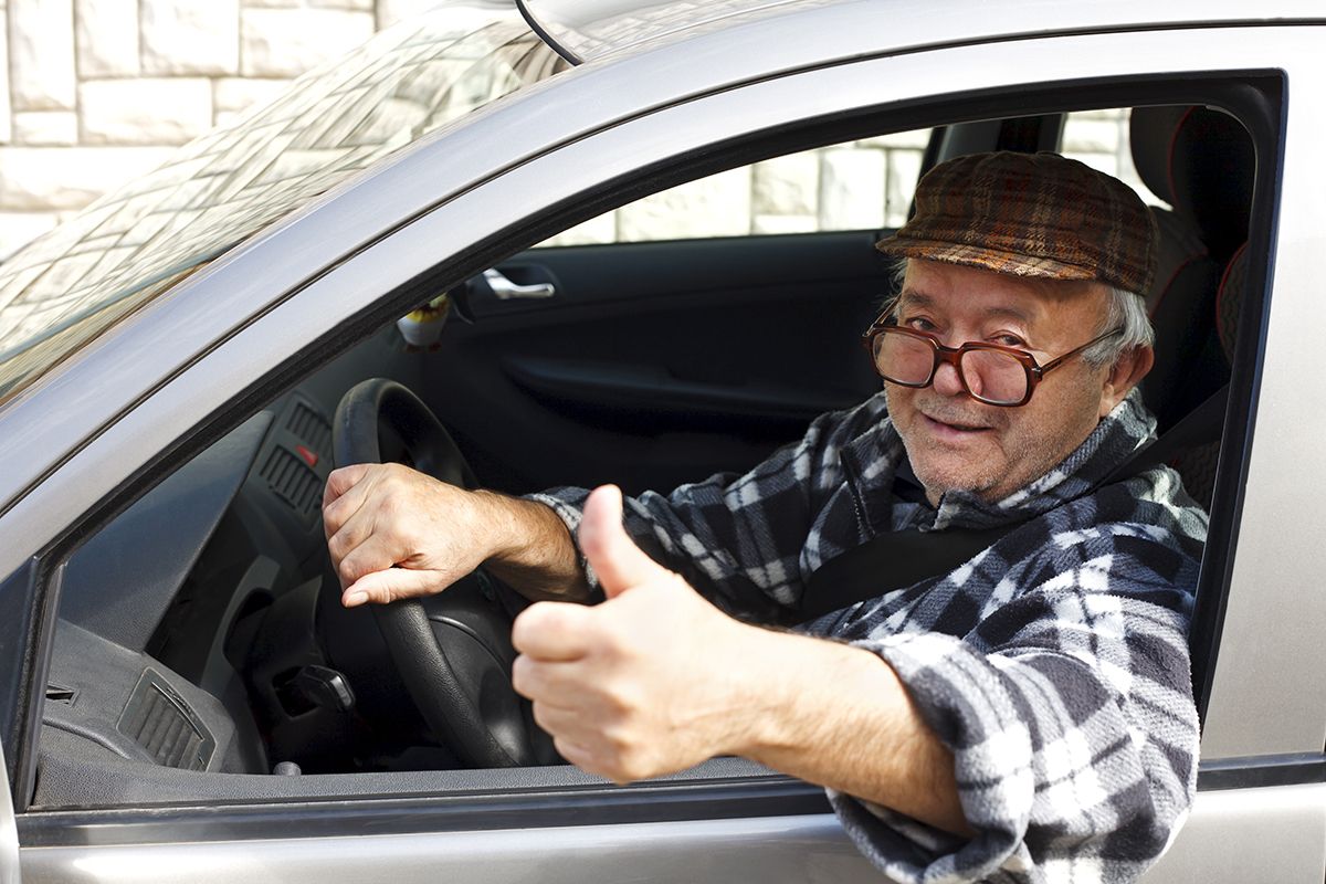 Elderly,Man,Driving,The,Car,And,Shows,The,Thumb