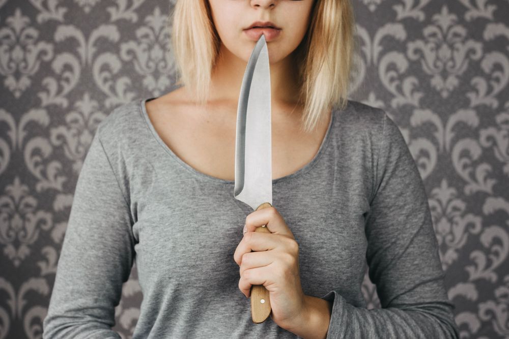 Woman,Blonde,Holding,A,Kitchen,Knife,In,Her,Hand,,Threat,