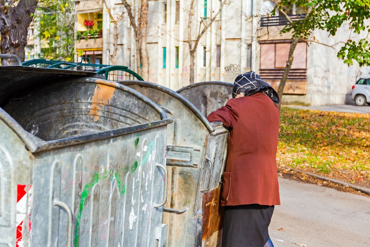 Homeless,Woman,Is,Searching,For,Food,In,Garbage,Dumpster/woman,In