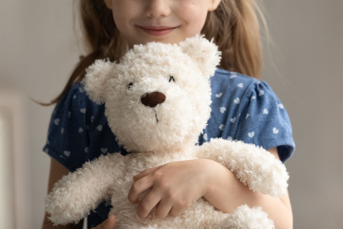 Close,Up,Of,Teddy,Bear,In,Arms,Of,Child.,Happy
