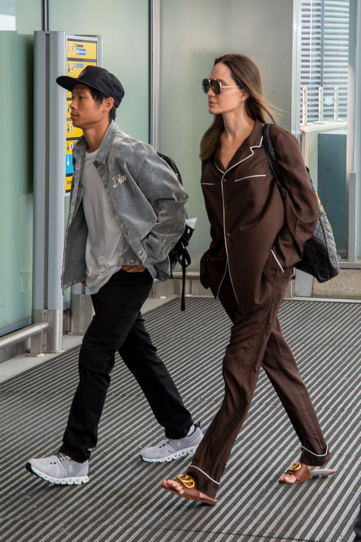 EXCLUSIVE: AJ In Her PJ's! Angelina Jolie And Son Pax Spotted Flying Out Of Heathrow Airport