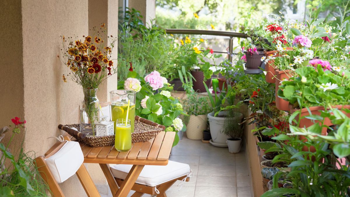 Beautiful,Terrace,Or,Balcony,With,Small,Table,,Chair,And,Flowers.