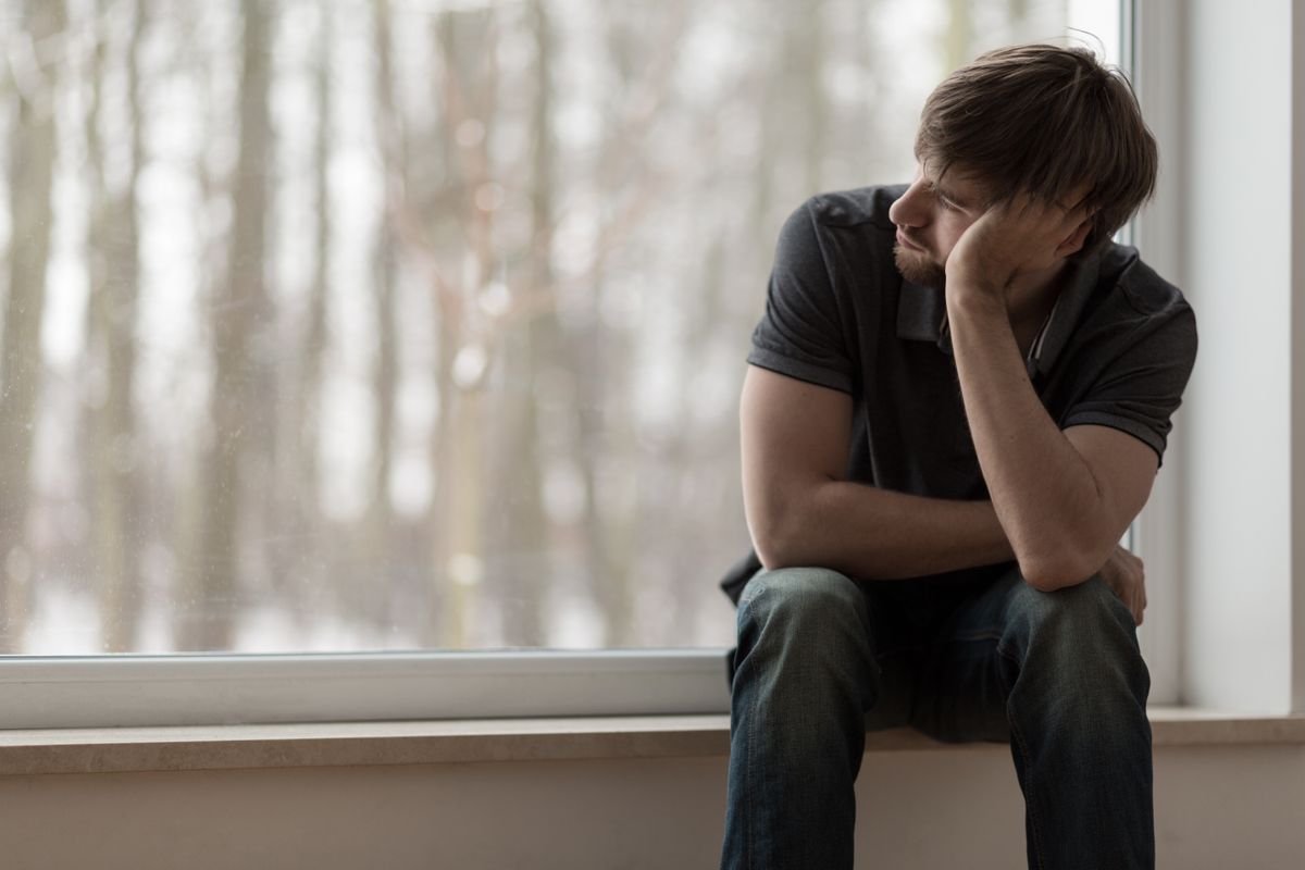 Young,Miserable,Depressed,Man,Sitting,And,Thinking