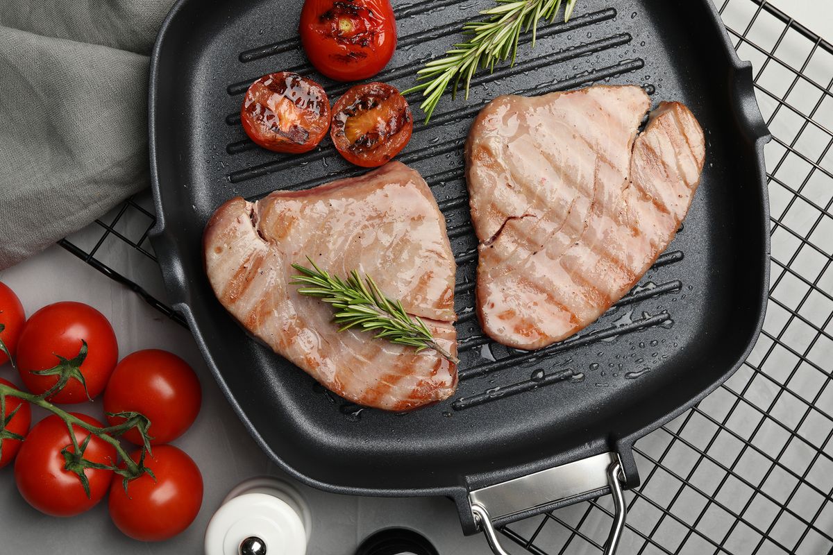 Delicious,Tuna,Steaks,With,Rosemary,And,Tomatoes,On,Grey,Table,