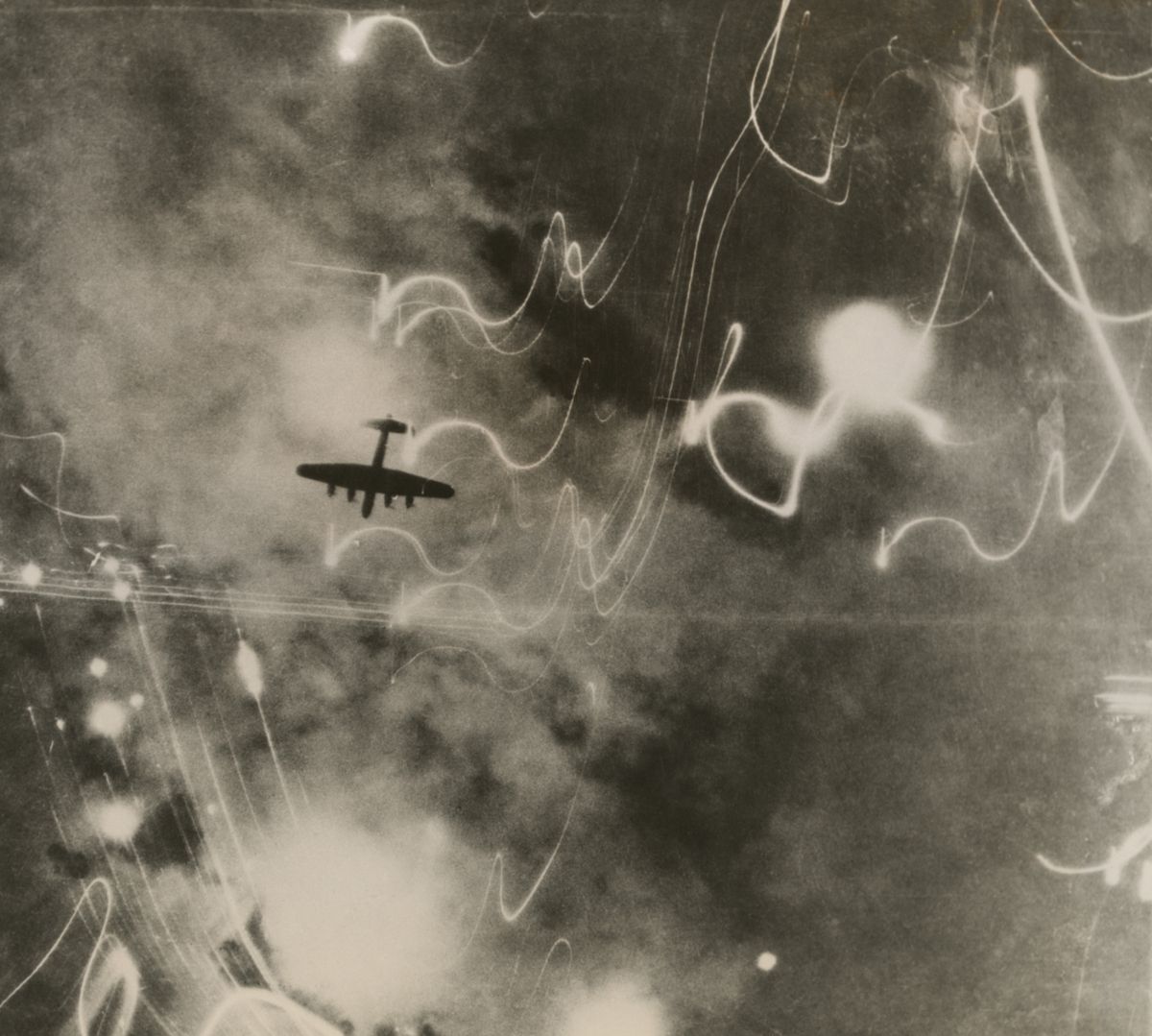 British,Raf,Bomber,And,Trails,Of,Light,From,Incendiary,Bombs.