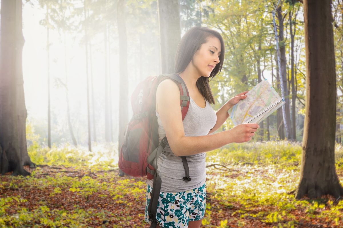 Attractive,Woman,With,Backpack,Lost,In,Forest