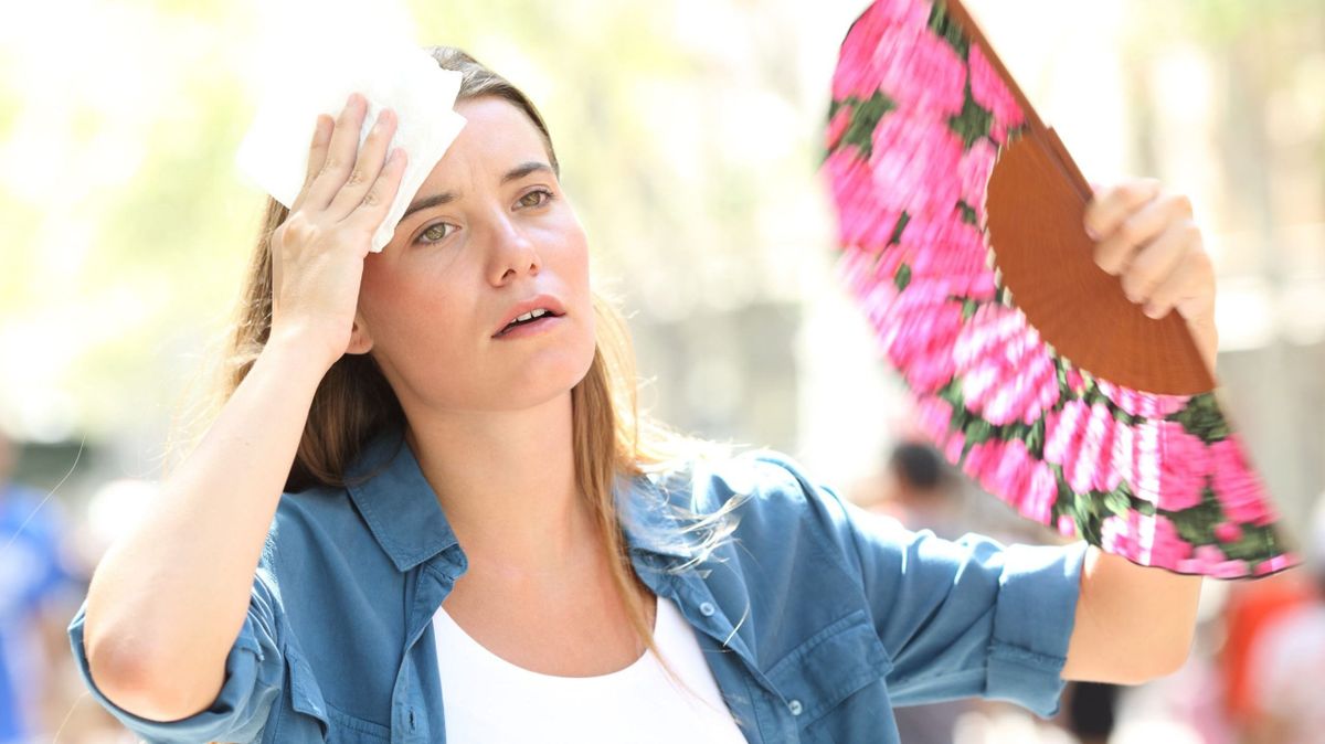 Sad,Woman,Fanning,And,Sweating,Suffering,A,Heat,Stroke,On