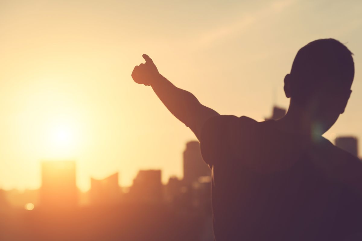 Successful,Man,Aiming,At,Sunset