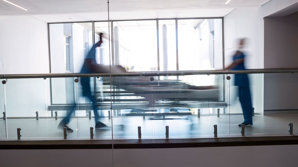 Team of doctors taking pregnant woman to operation theatre in the hospital