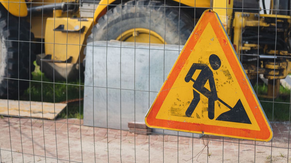 Yellow,Heavy,Construction,Machinery,Behind,The,Fence
