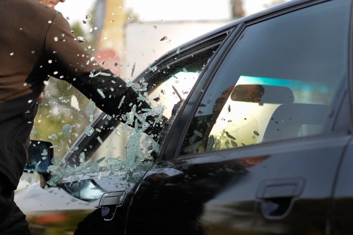 Man,Breaking,A,Car's,Window,In,A,Million,Of,Pieces