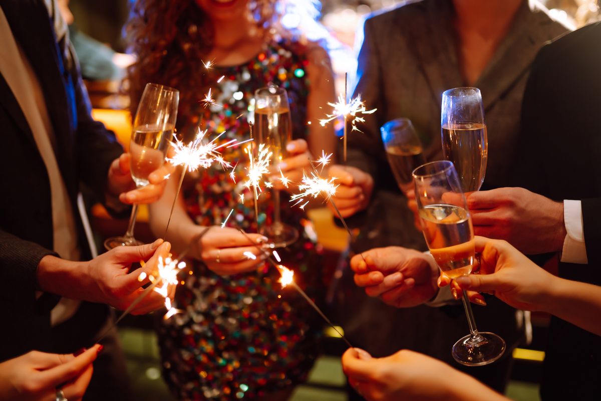 Glowing,Sparkles,In,Hands.,Group,Of,Happy,People,Enjoying,Party