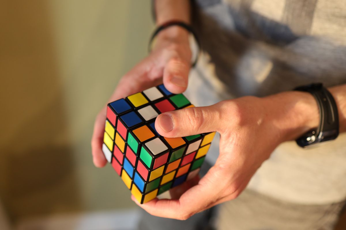 Man's,Hand,Holding,A,Rubik's,Cube,,Man,Playing,With,A